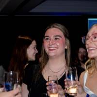 Group of grad smile holding champagne